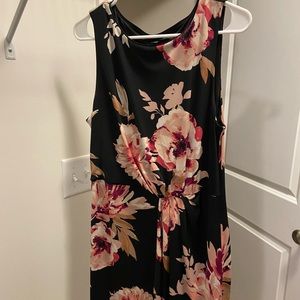 White House Black Market black dress with flower detail. Some ruching in front.